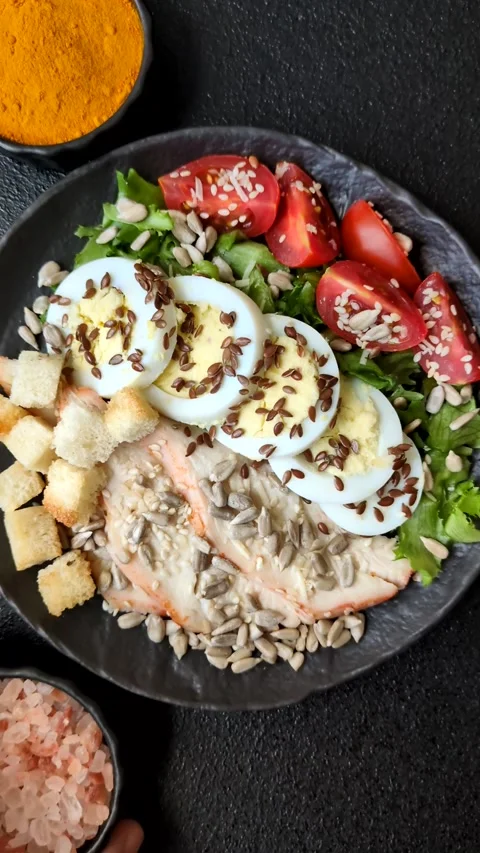 Bowl with caesar salad with chicken, parmesan cheese, tomatoes, croutons, lettuc Stock Footage 308531488