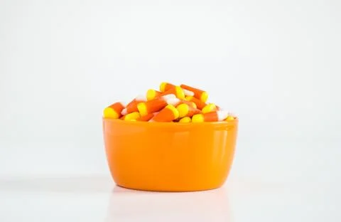 Bowl of candy corn isolated on white Stock Photos