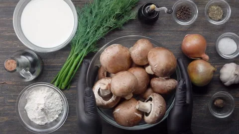 A bowl of champignons is placed on the table with other ingredients Stock Footage 311935272