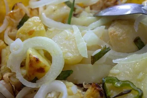 A bowl of cod fish cooked with potatoes, onions and seasonings Stock Photos