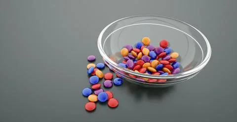 Bowl of colored candy on dark Stock Photos