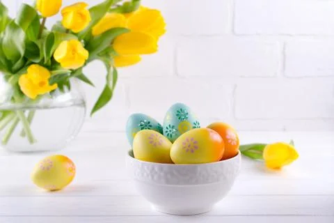 Bowl with colorful Easter eggs,spring easter decoration on white wooden table Stock Photos