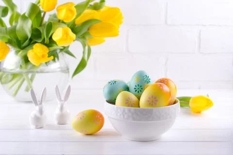 Bowl with colorful Easter eggs,spring easter decoration on white wooden table Stock Photos