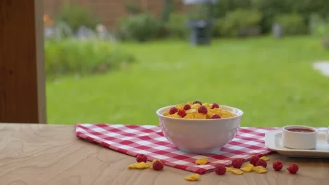 Bowl of cornflakes with raspberry Stock Footage 137626180