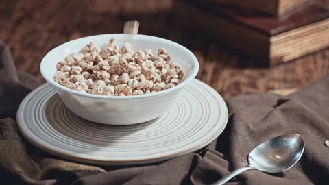 Bowl of Crispy Puffed Rice Cereal on Rustic Table Vídeos de archivo 344687207