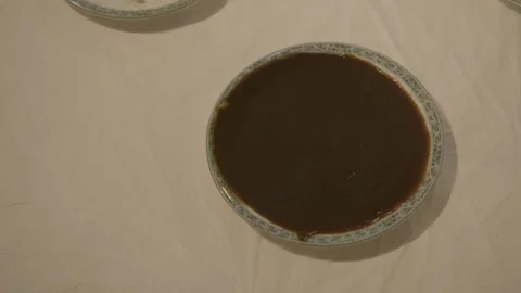 Bowl of Dark Sauce on Restaurant Table in Beijing, China, Overhead Close-Up Stock Footage 345769633