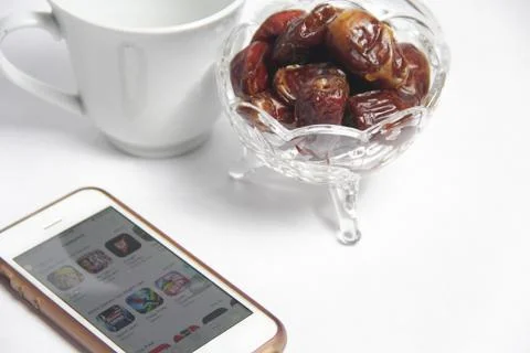 Bowl of dry dates fruit on white background Stock Photos