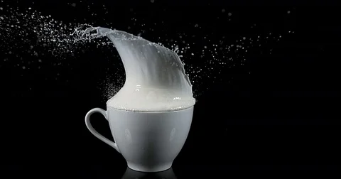 Bowl with Exploding Milk against Black Background, slow motion 4K Stock Footage 75969501