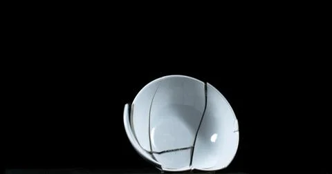 Bowl falling and exploding on Black Background Stock Photos