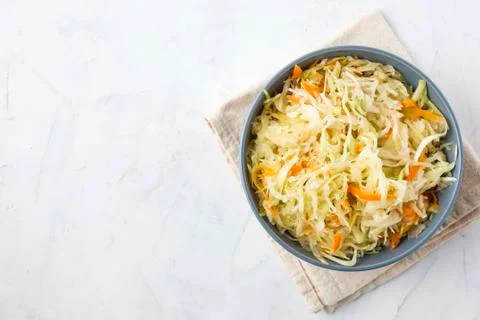 Bowl of fermented cabbage on plaster surface Stock-Fotos