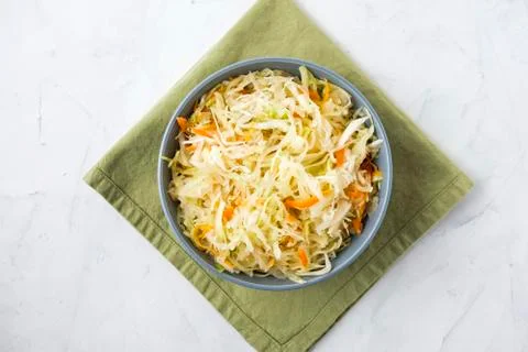 Bowl of fermented cabbage on plaster surface Stock Photos