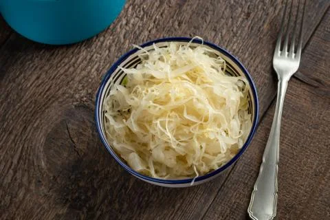 A bowl of fermented cabbage on a table Stock Photos