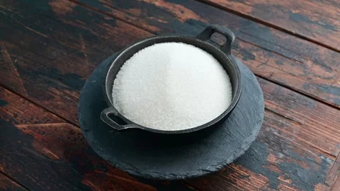 Bowl filled with white sugar on dark wooden surface Stock Footage 305230141