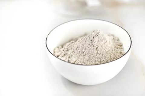 Bowl of flour on a light table. selective focus Stock Photos