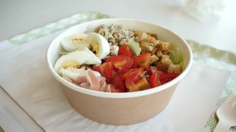 Bowl with fresh Caesar salad of vegetables and beacon meat, eggs and croutons in Stock Footage 166233716