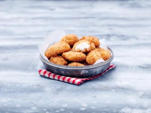 Bowl of fried chunky cod breaded nuggets on steel table Stock Photos