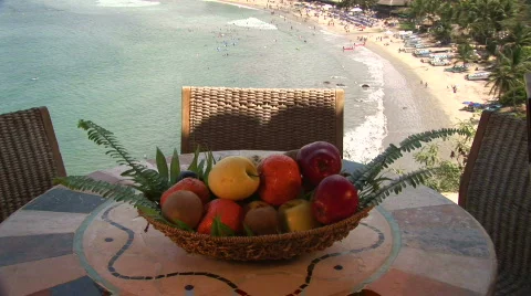 A bowl of fruit with beach in the background Stock Footage 574342