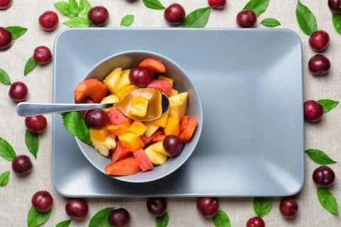 Bowl of fruit salad on rectangular plate. Stock Photos