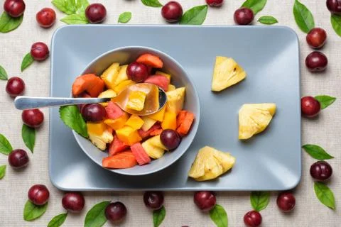 Bowl of fruit salad on rectangular plate. Stock Photos