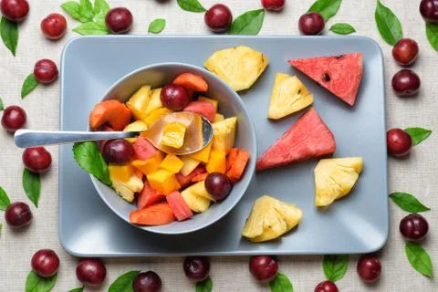 Bowl of fruit salad on rectangular plate. Stock Photos