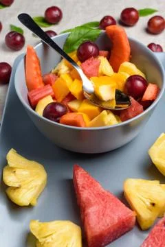 Bowl of fruit salad on rectangular plate. Stock Photos