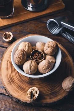 Bowl full of walnuts and nutcracker Stock Photos