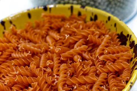 A bowl of fusilli flavored with pepper ready to cook Stock Photos