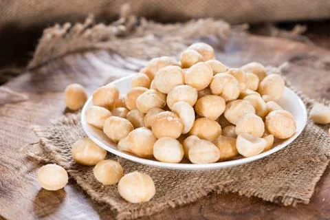 Bowl with macadamia nuts Stock Photos