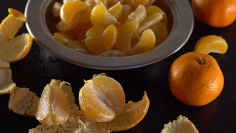 A bowl of mandarins on a black table. 動画素材 69936878