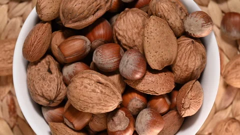 Bowl of mixed nuts with almonds, walnuts, and hazelnuts rotating Stock Footage 333124778
