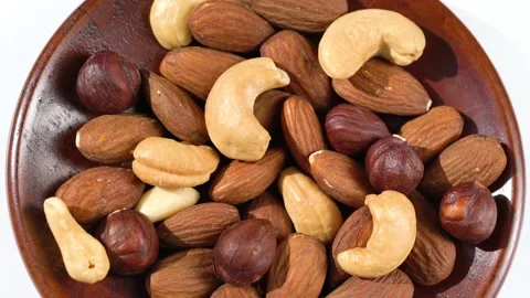 Bowl with mixed nuts on white background. Stock Footage 151342440