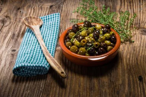Bowl of olives with thyme Stock Photos