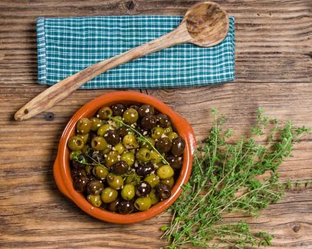 Bowl of olives with thyme 스톡 사진