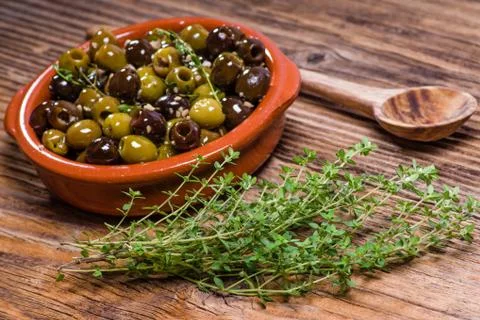 Bowl of olives with thyme 写真素材