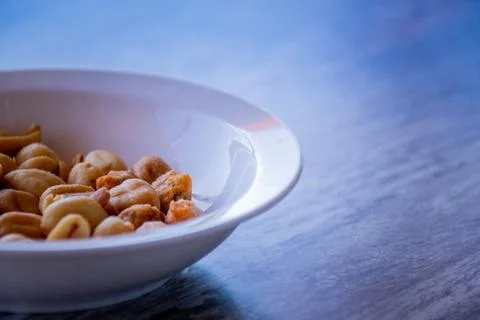 Bowl of peanuts on a woodden table Stock Photos