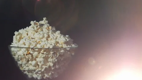 Bowl of pop corn, 3d viewing glasses in dark background and projector beam glare Video stock 111762211