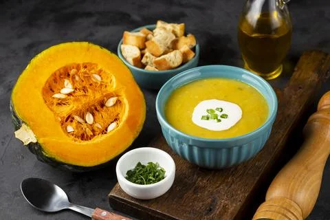 Bowl with pumpkin soup on the table. Stock Photos