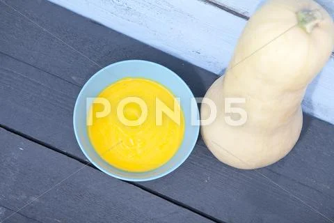 Bowl with pumpkin soup with wooden background Stock Photos