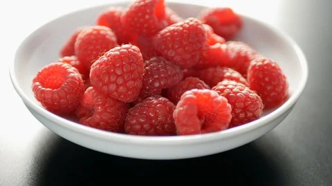 Bowl of raspberries Stock Footage 104433242