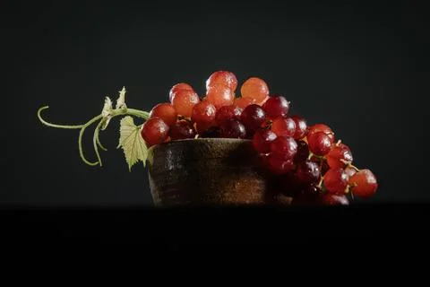 Bowl of red grapes on a solid black background 스톡 사진