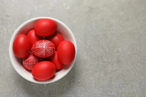 Bowl with red painted Easter eggs on table, top view. Space for text Stock Photos