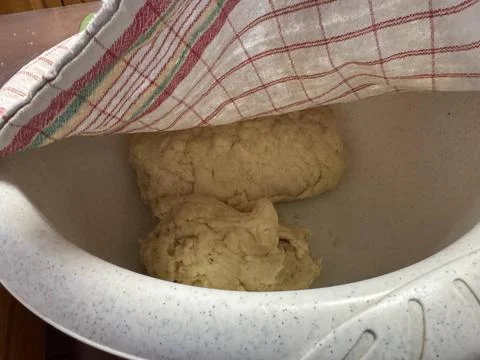 Bowl of risen dough covered with kitchen towel for homemade baking Stock Photos