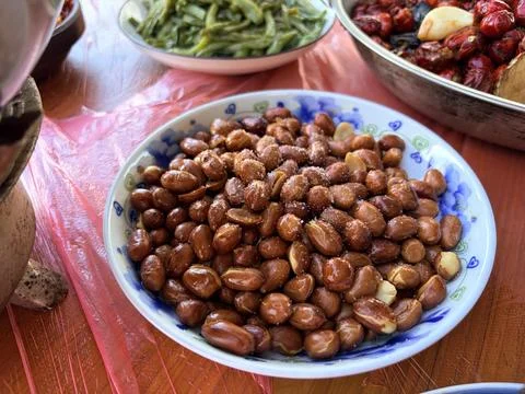 Bowl of Roasted Peanuts with Salt on a Table Stock Photos