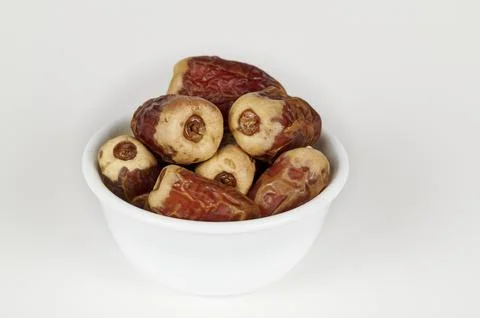 Bowl of Sagai dates on white Stock Photos
