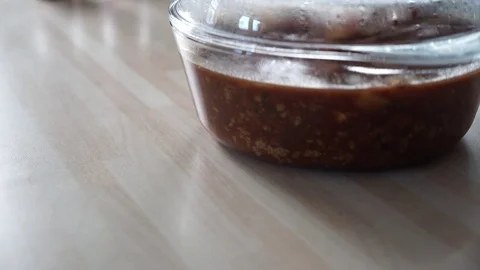 Bowl of sauce placed onto a table in kitchen Stock-Footage 73449396