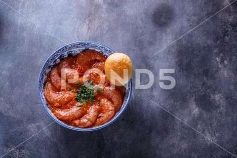 Bowl of shrimps in spicy tomato sauce, singaporean cuisine, copyspace Stock Photos