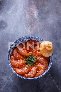 Bowl of shrimps in spicy tomato sauce, singaporean cuisine, copyspace Stock Photos