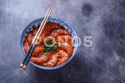 Bowl of shrimps in spicy tomato sauce, singaporean cuisine, copyspace Stock Photos