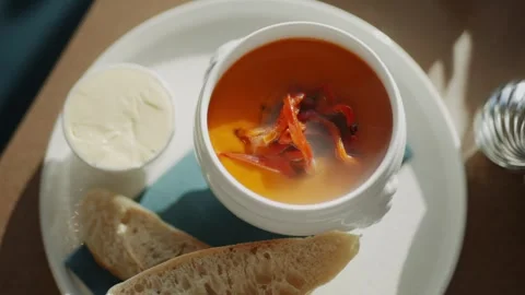 A bowl of soup with a slice of bread on the side Stock Footage 295993997
