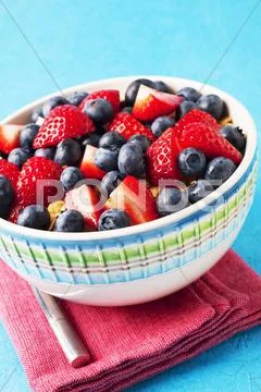 A bowl of strawberries, blueberries and muesli Stock Photos